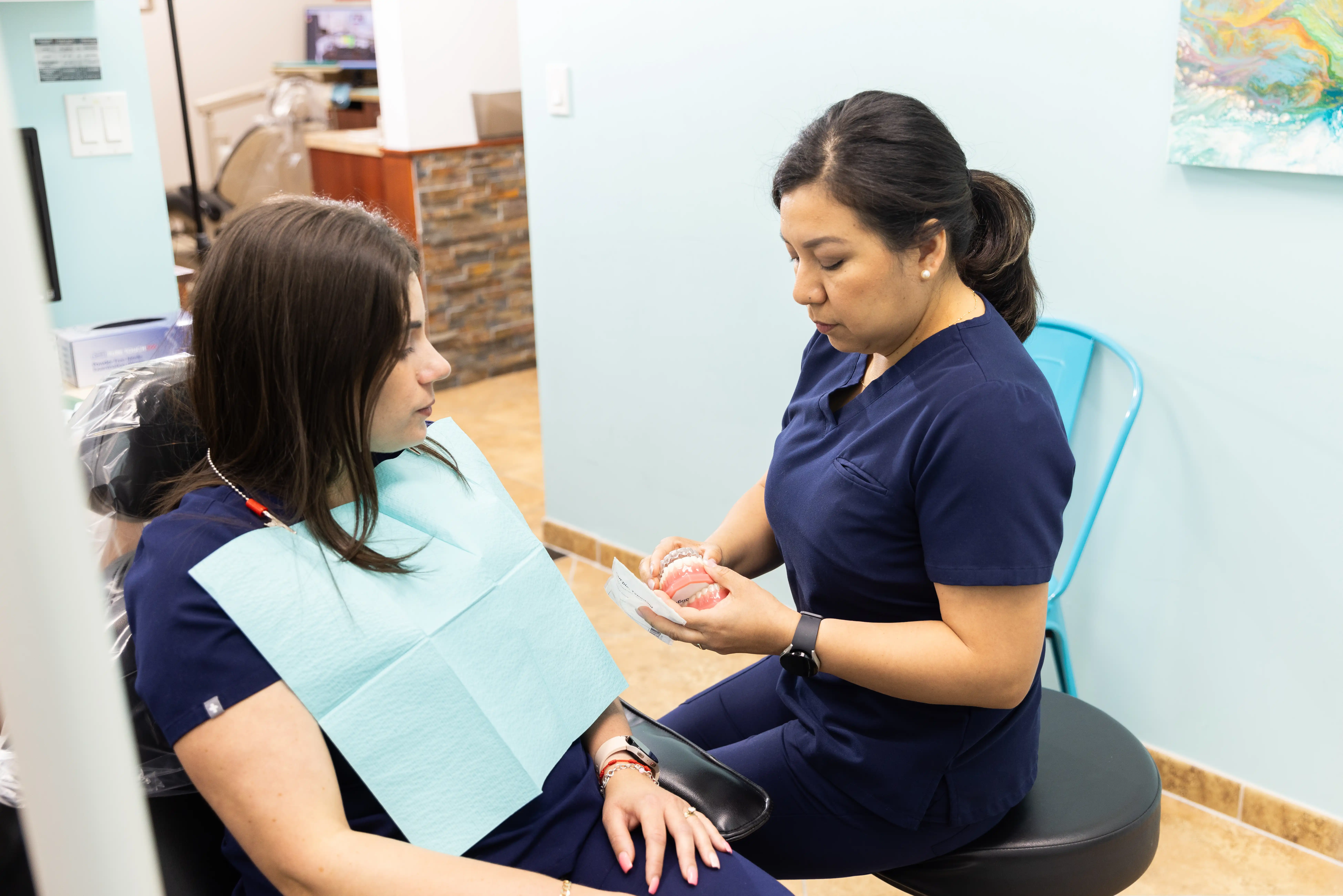 Hygienist explaining dental crowns to a patient